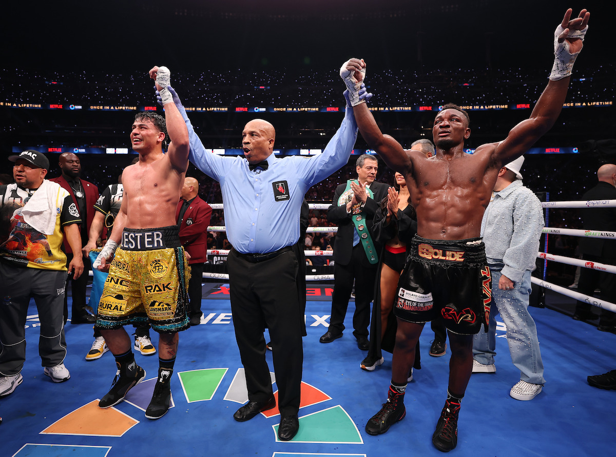 Lester Martinez and Christian M'billi raising hands in honor of their split draw after their super middleweight WBC interim title fight.