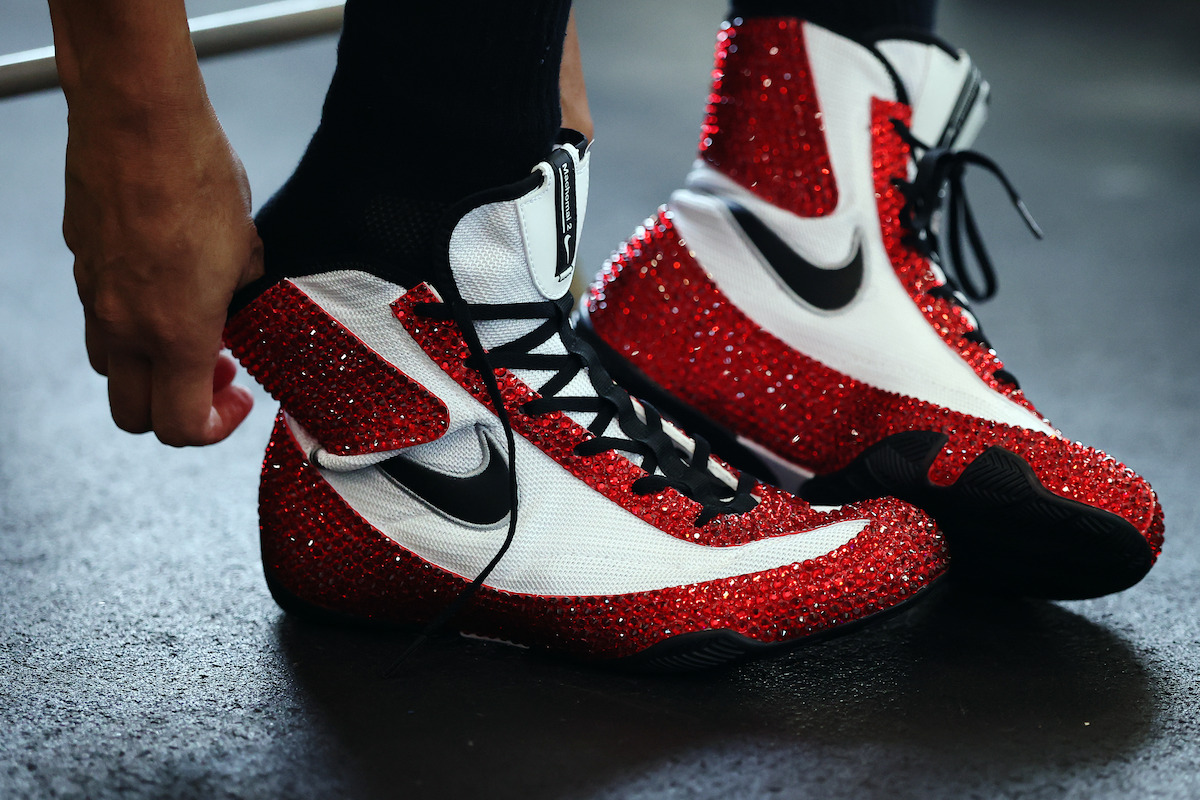 Amanda Serrano puts on her red boxing shoes.