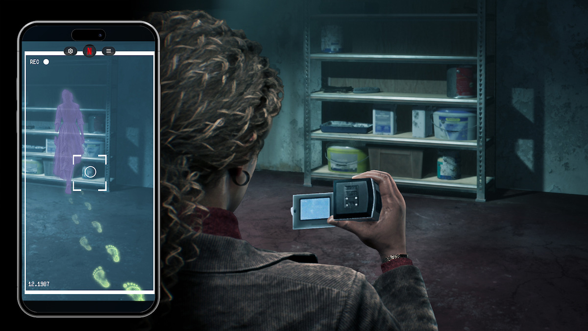 A person in a dark storage room uses a camera and phone to capture evidence, revealing ghostly footprints and a purple apparition on their screen near shelves with paint cans and cleaning supplies.
