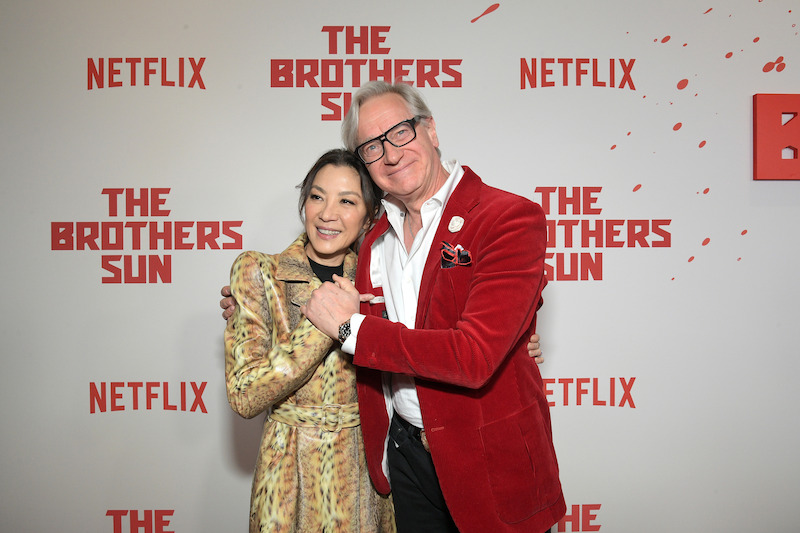 Michelle Yeoh and Paul Feig smile together on the red carpet at Netflix's 'The Brothers Sun' Los Angeles Premiere at Netflix Tudum Theater