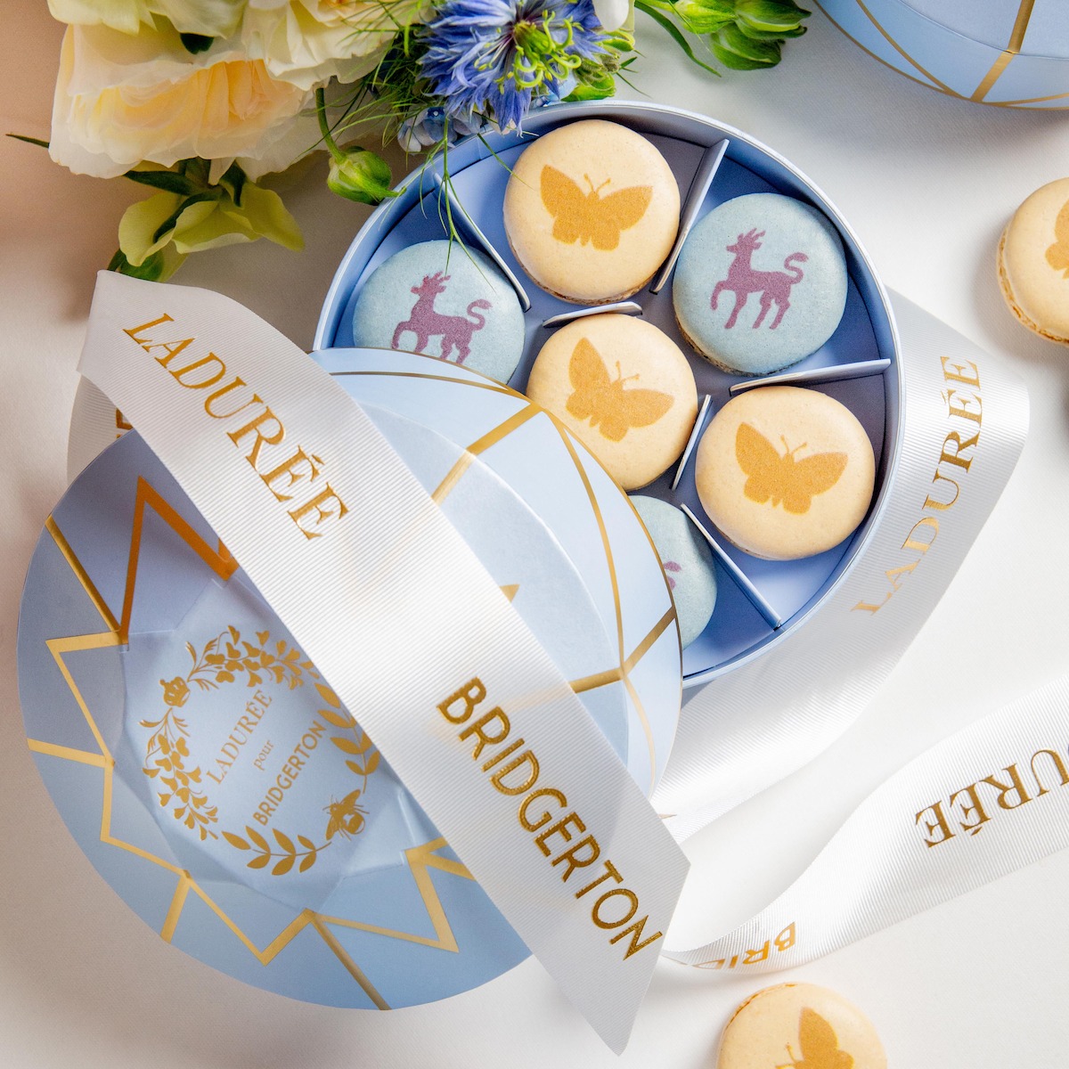 A box of blue and yellow macacrons with from the ‘Bridgerton’ collaboration with Ladurée