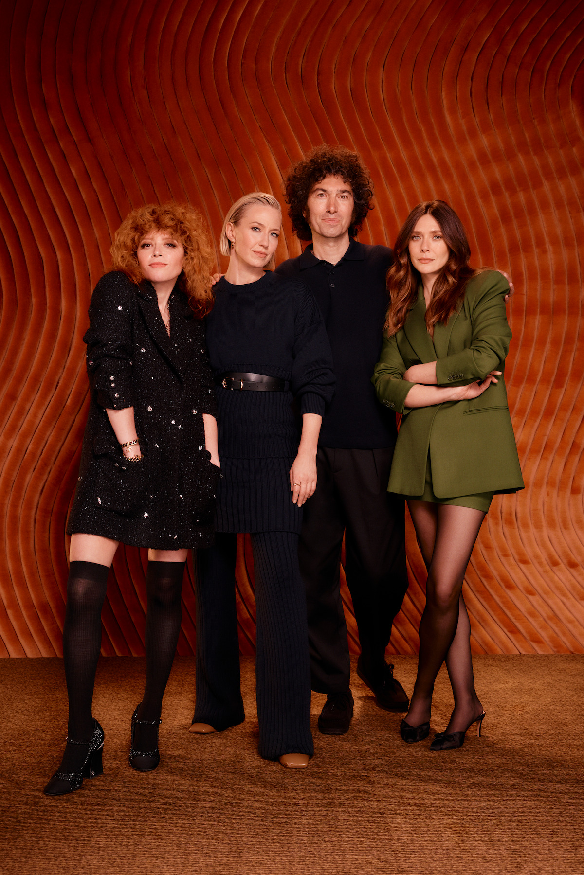 Natasha Lyonne, Carrie Coon, Azazel Jacobs, and Elizabeth Olsen pose together against a burnt orange background.