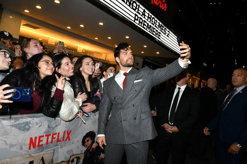 Henry Cavill poses with fans outside of the Paris Theater.