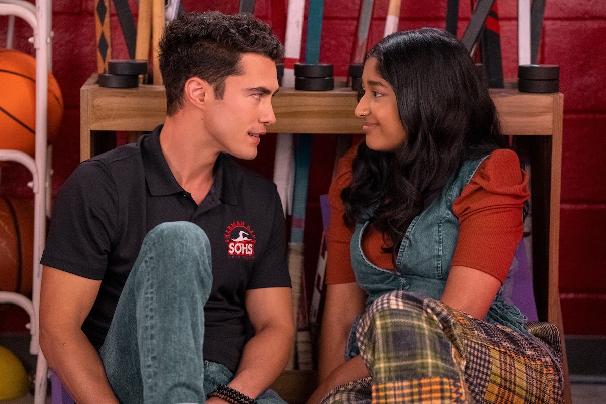 Darren Barnet as Paxton Hall-Yoshida and Maitreyi Ramakrishnan as Devi sitting in a closet in ‘Never Have I Ever’ Season 4.