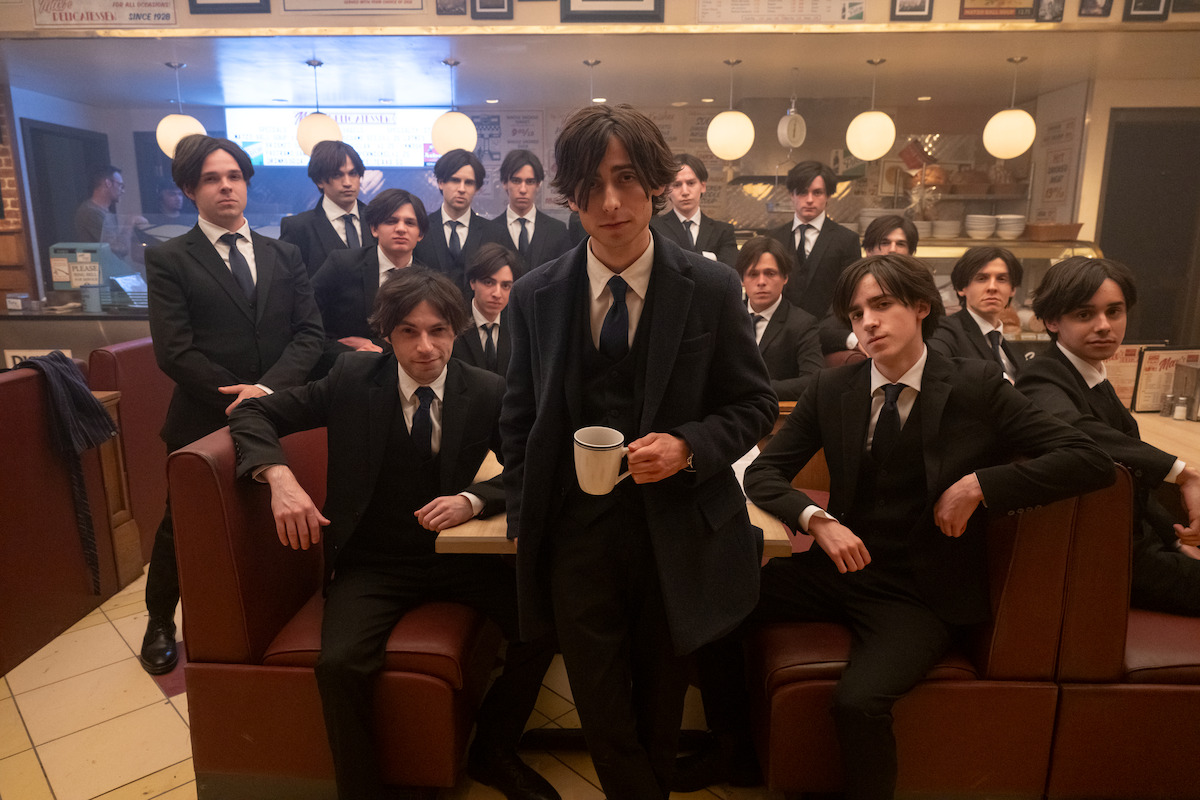 Aidan Gallagher as Number Five in the series “The Umbrella Academy” poses with the other “Five” behind the scenes during production.