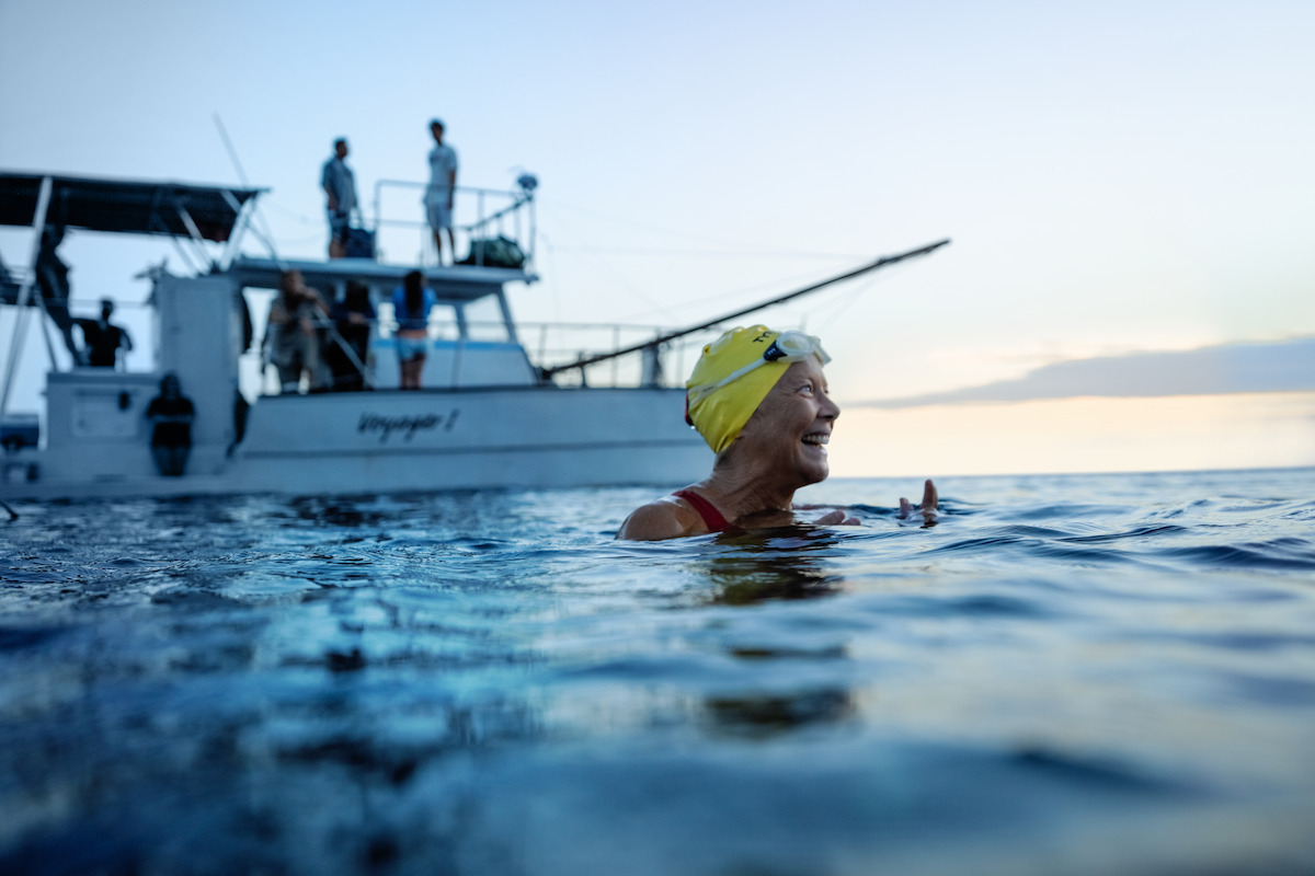 Annette Bening treads water next to a boat in a still from ‘NYAD.’