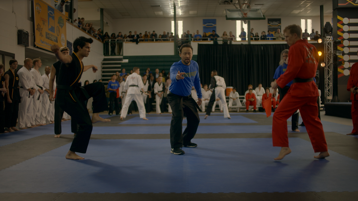 Miguel stands in Crane pose, ready to strike his opponent on the mat