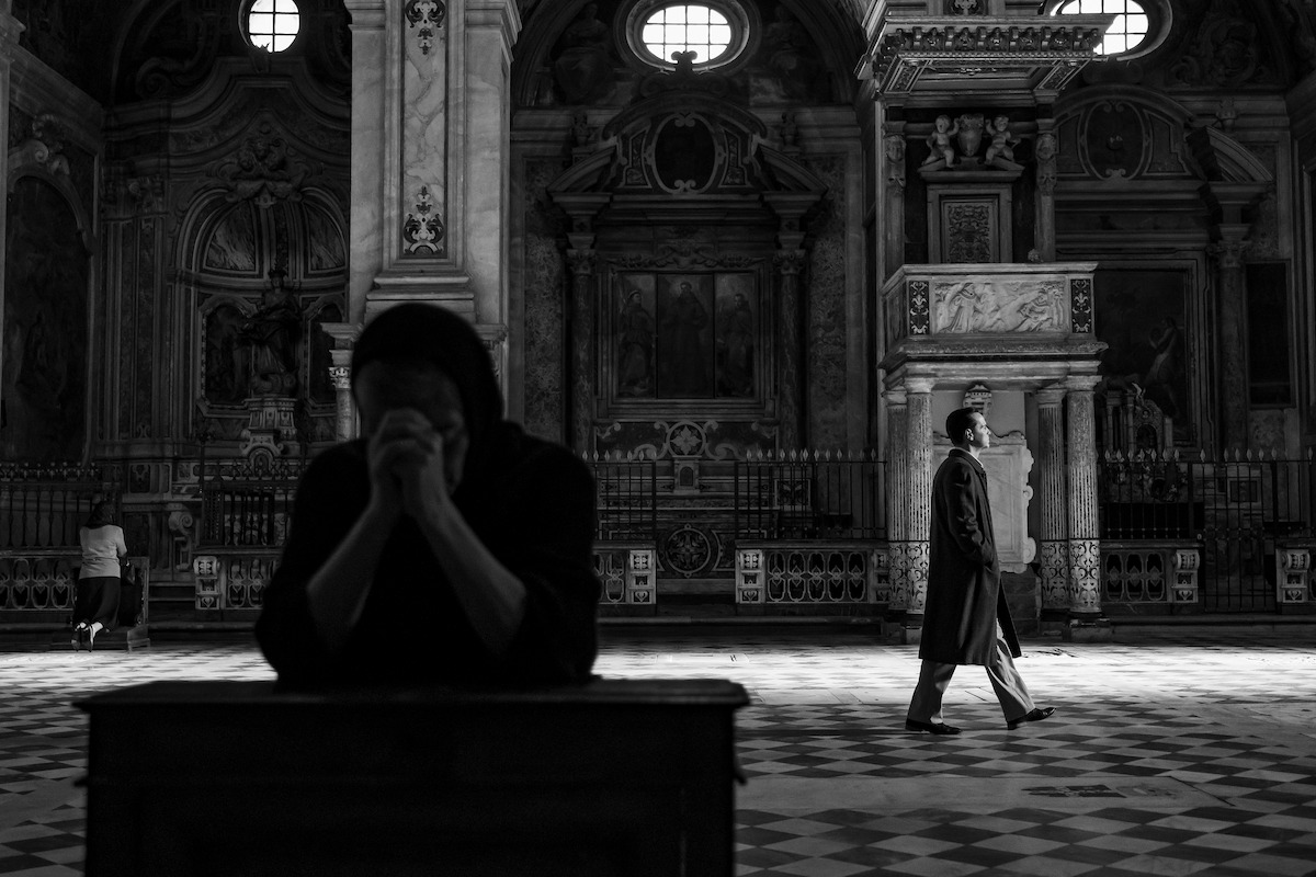 Black=and-white photo of Andrew Scott as Tom Ripley walking through a cathedral in ‘Ripley’