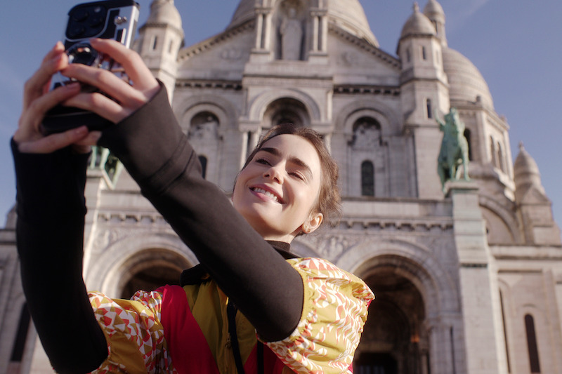 Lily Collins as Emily takes a selfie in Rome in Season 4 of 'Emily in Paris'