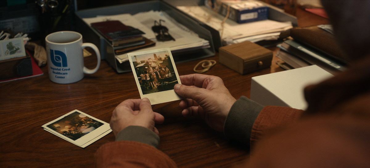 Hands holding a photograph in Season 7 of ‘Black Mirror’