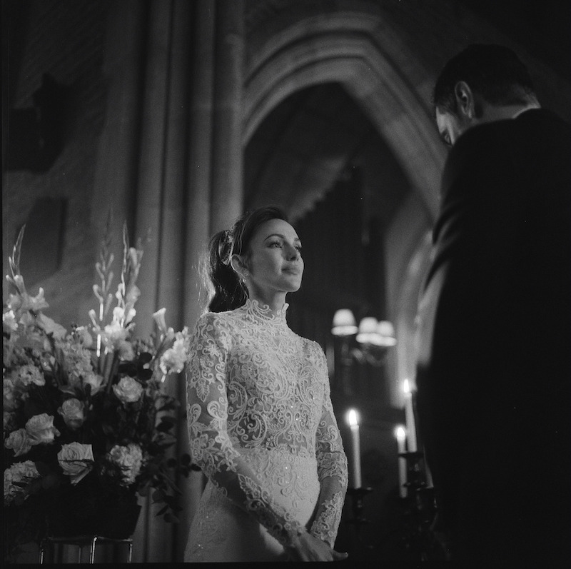 Black-and-white image of Michelle Keegan as Michelle Stern wearing a wedding dress behind the scenes in Season 1 of 'Fool Me Once'