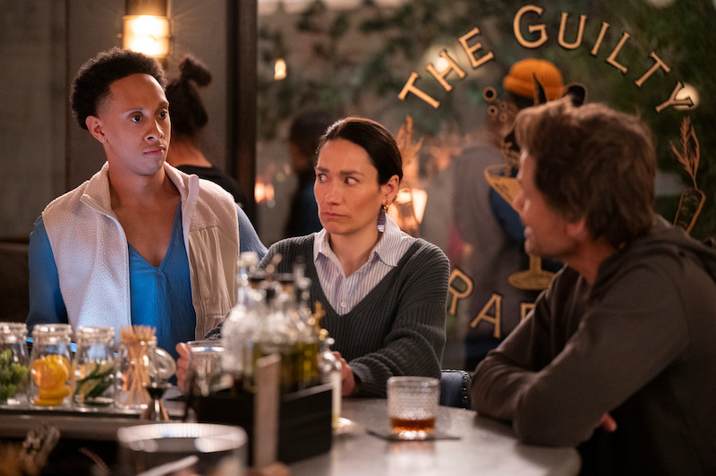 Aaron Branch as Malcolm, Sian Clifford as Anna, and Rob Lowe as Ellis sit at a bar together in Season 2 of 'Unstable'