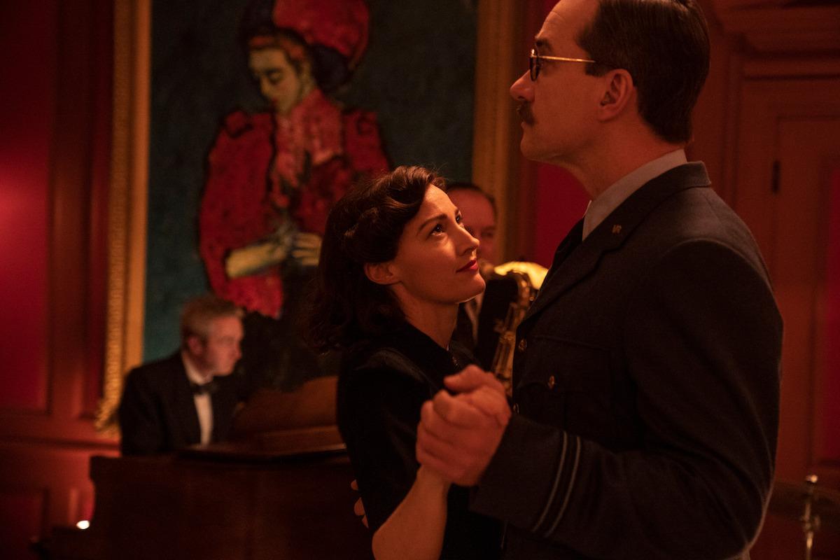 Characters slow dance in a scene from 'Operation Mincemeat'