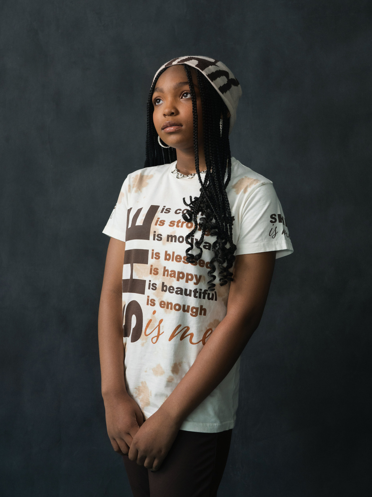 Aubrey Smith wears a white shirt and matching hat.