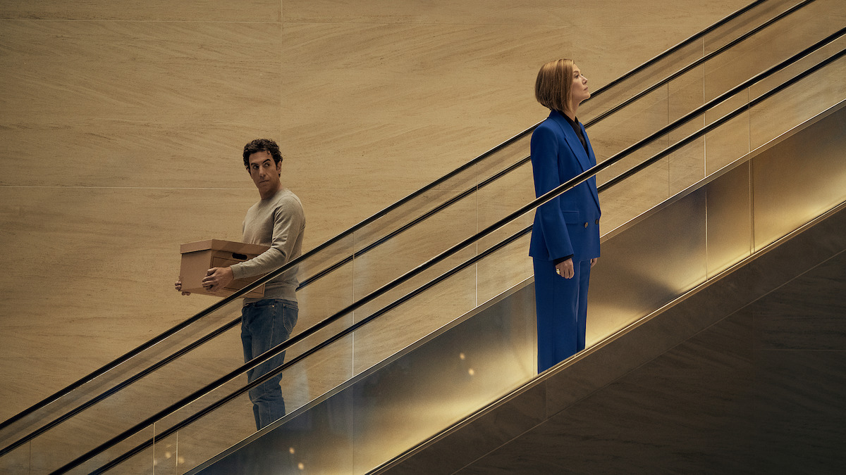 Ladies First. (L-R) Sacha Baron Cohen as Damien Sachs and Rosamund Pike as Alex Fox in Ladies First. Cr. Rob Youngson/Netflix © 2026.