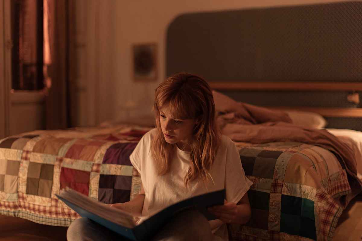 Catalina Sopelana as Clara reads through a binder in ‘The Crystal Cuckoo.’
