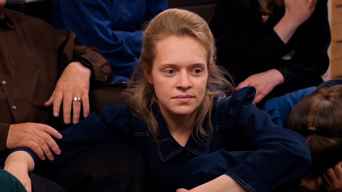 Nomz sits at Samuel’s feet in the documentary.