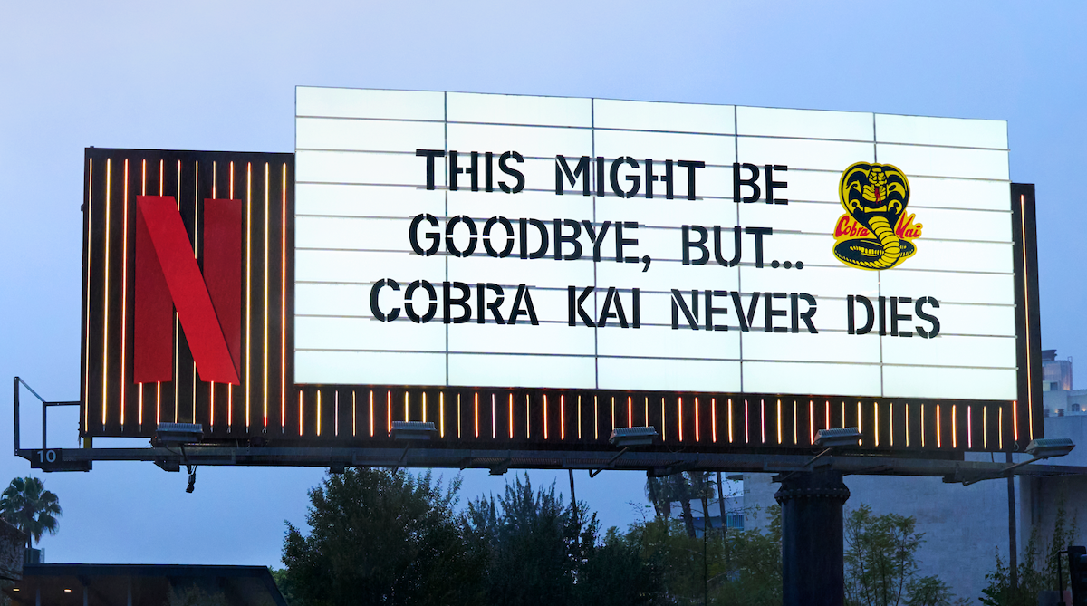 Cobra Kai Sunset Blvd billboard - ‘This might be goodbye, but… Cobra Kai Never Dies’ with a Cobra Kai snake logo on the billboard.