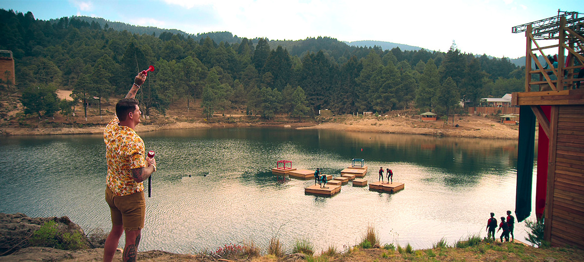 Taylor Lewan looks into the distance as players compete during a challenge in ‘Battle Camp’