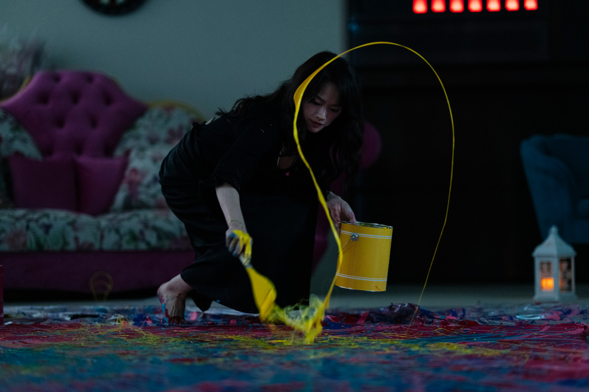 Chun Woo-hee as Number 8 flicks paint from a paintbrush in ‘The 8 Show.’