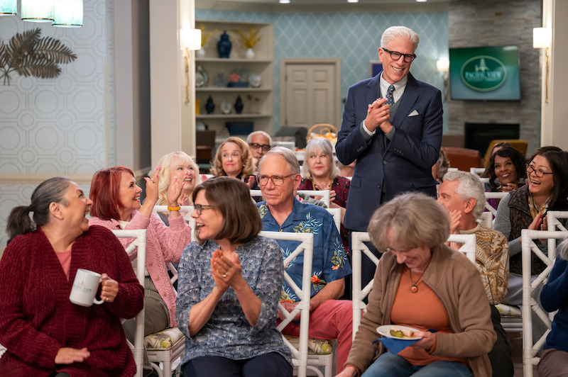 Ted Danson as Charles stands in a group of seated people applauding in Season 1 of 'A Man on the Inside'