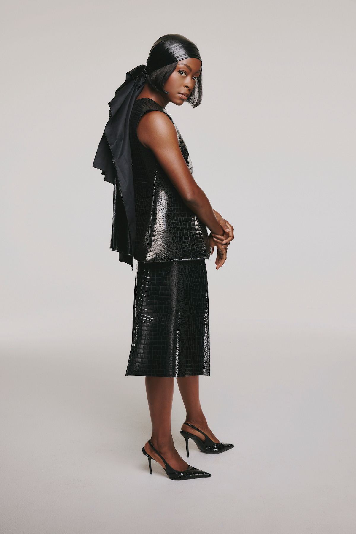 Danielle Deadwyler in a black ensemble against a white background.