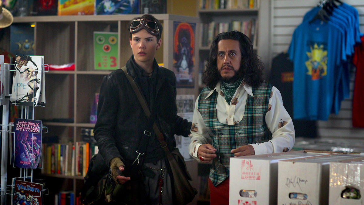 Zebastin Borjeau as Dylan and Kris Siddiqi as The Collector stand together in a shop in Season 1 of ‘I Woke Up a Vampire.’