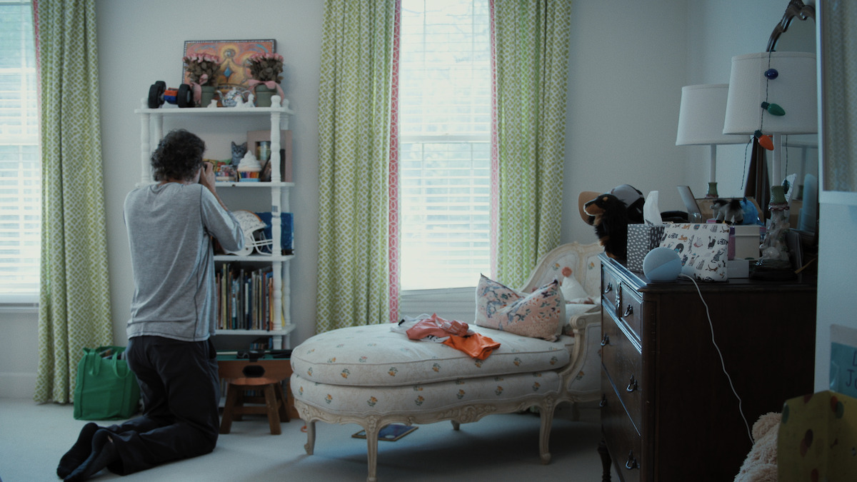 Photographer Lou Bopp takes a photo of a bookshelf in a child’s bedroom.