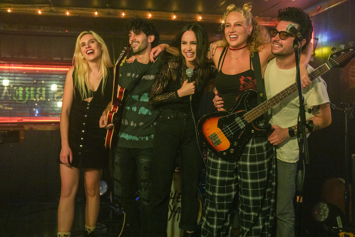 Cassie and her band finish a set, enjoying their new-found success in the music scene. 