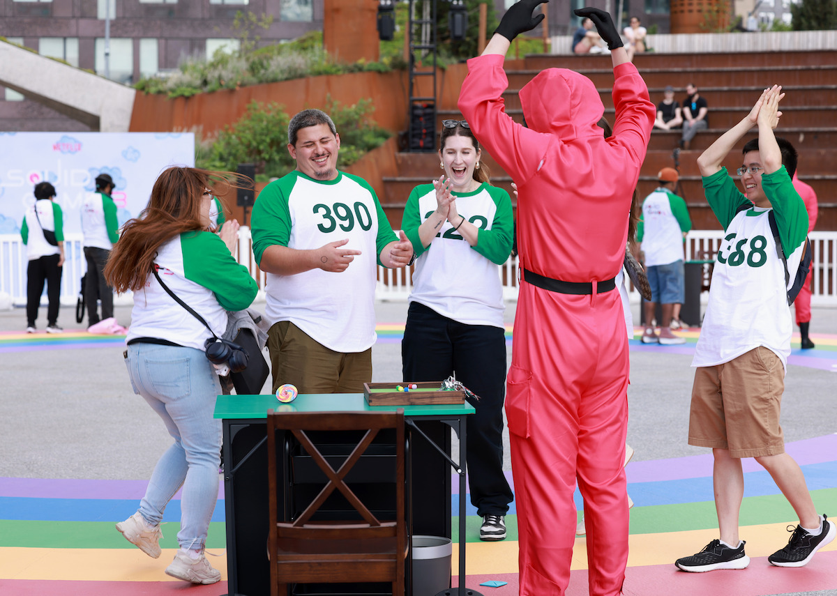 Fans compete next to a Pink Guard during a ‘Squid Game’ Season 3 fan event in Brooklyn, New York.