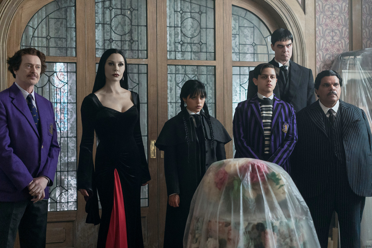 Steve Buscemi as Barry Dort, Catherine Zeta-Jones as Morticia Addams, Jenna Ortega as Wednesday Addams, Isaac Ordonez as Pugsley Addams, Joonas Suotamo as Lurch and Luis Guzmán as Gomez Addams in ‘Wednesday’ Season 2.