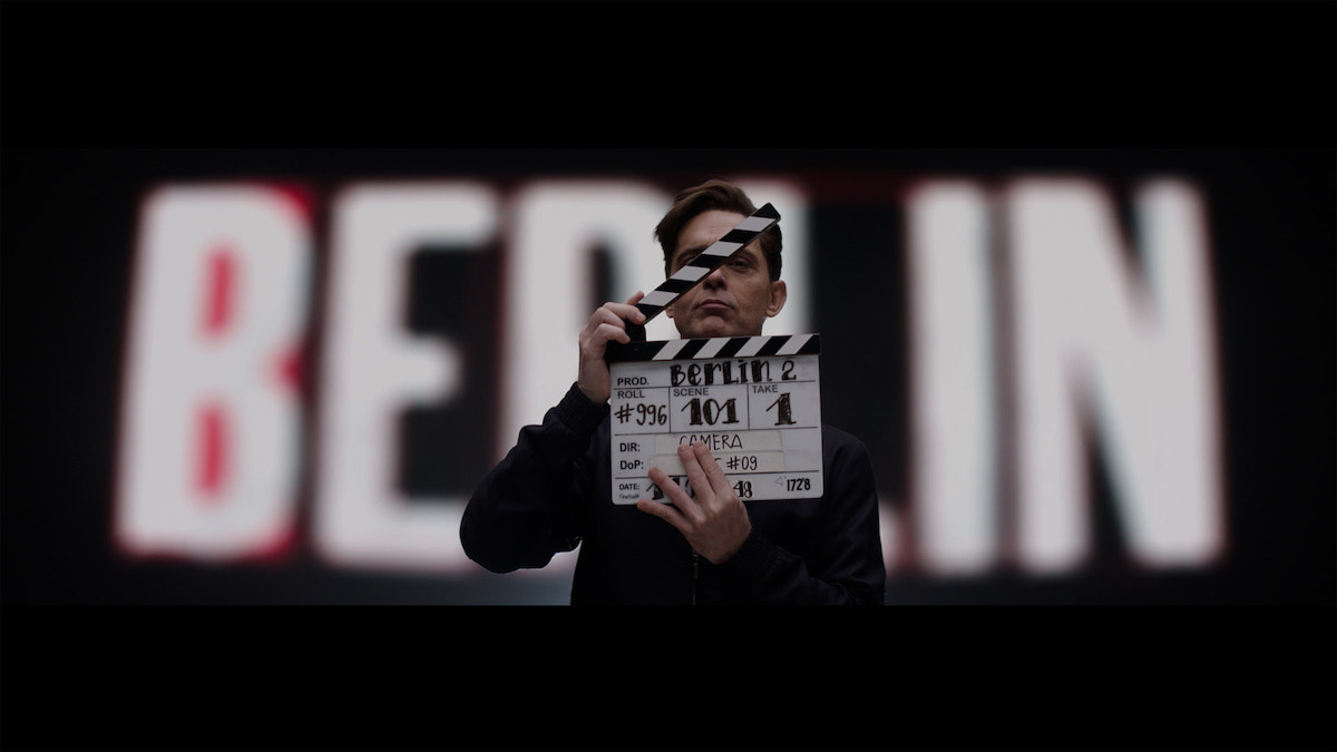 Pedro Alonso using a film clapboard