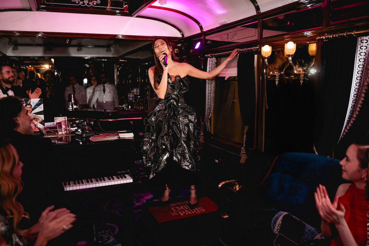 Ashley Park sings at the 'Emily in Paris' Season 5 Train Experience.