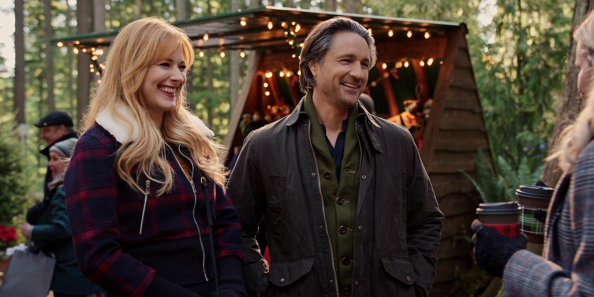 Alexandra Breckenridge as Mel Monroe and Martin Henderson as Jack Sheridan smile together at a Christmas market in Season 5 of ‘Virgin River’