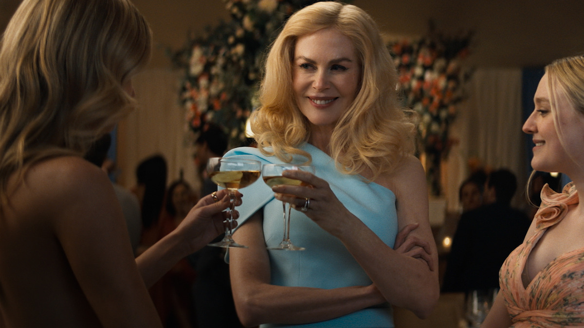 Nicole Kidman as Greer Winbury holds a drink next to Dakota Fanning as Abby Winbury