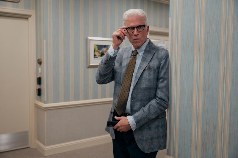 Ted Danson as Charles stands in a hallway reaching up to touch his spyglasses in Season 1 of 'A Man on the Inside'