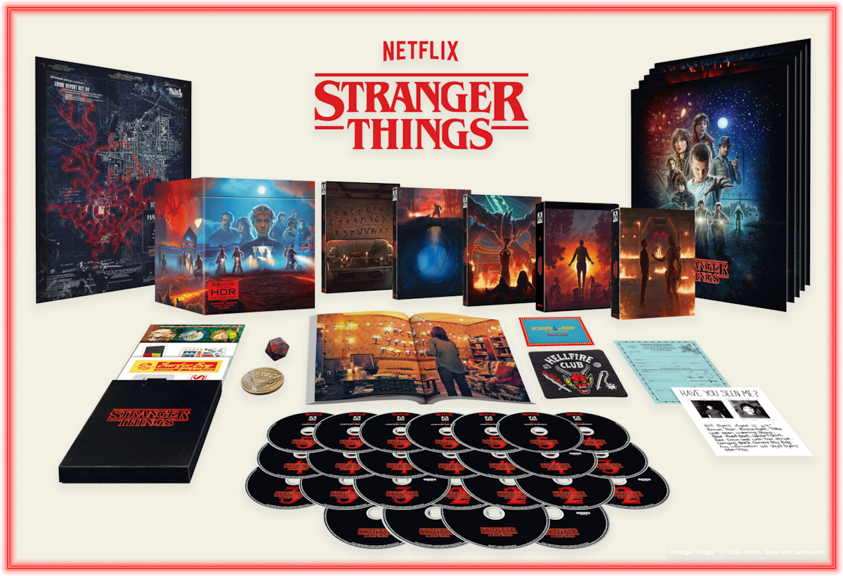 Stranger Things collector's box set with DVDs, character artwork, maps, cards, posters, and memorabilia arranged on a white surface, featuring promotional images and themed packaging.