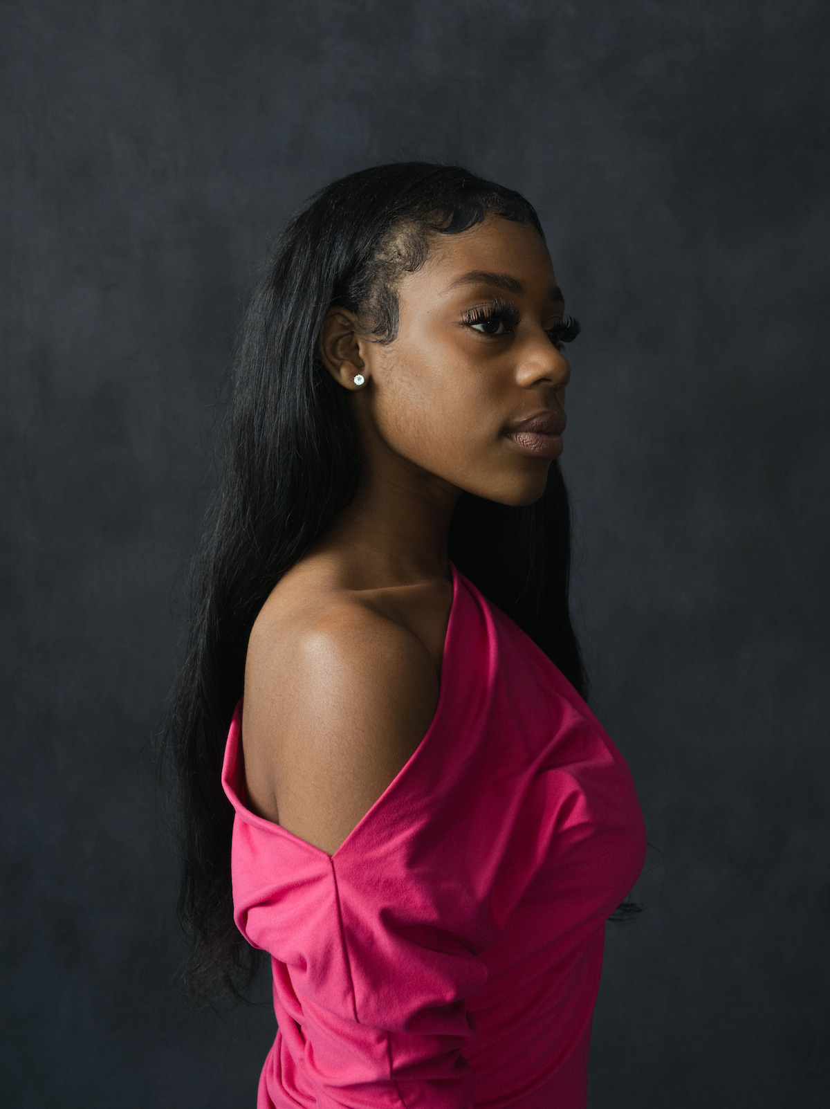 Raziah Lewis wears a hot pink off-the-shoulder top.
