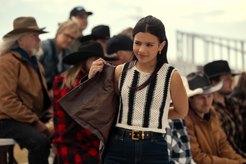 Rodriguez as Jackie in a black and white top at an outdoor event in 'My Life with the Walter Boys' Season 2