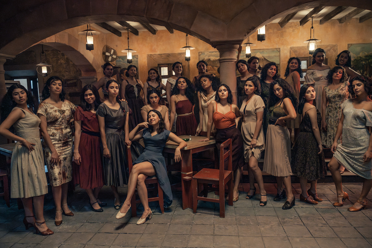 Sonia Couoh as Aurora, Sofía Espinosa as María Del Carmen, Fernanda Rivera as Luz María, Karen Martí as Socorro, Patricia Loranca as Evelia, Yessica Barroto Perryman as Blanca, Katia Rigoni as Felizia, and Mariané Cartas as Herminia pose in front of the brothel in a production still from ‘The Dead Girls.’