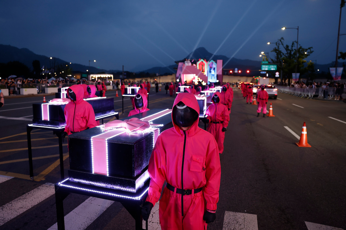 Pink Guards walk in the 'Squid Game' Season 3 parade in Seoul.