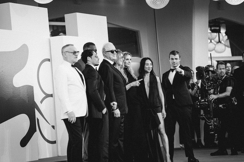 Jared Harris, Anthony Ramos, Idris Elba, Tracy Letts, Kathryn Bigelow, Rebecca Ferguson, Greta Lee, and Gabriel Basso in formal wear on the red carpet.