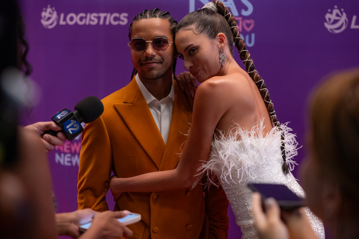 Tyler Dean Flores as Santi and Genesis Rodriguez pose for photos together in Season 1 of ‘Neon.’