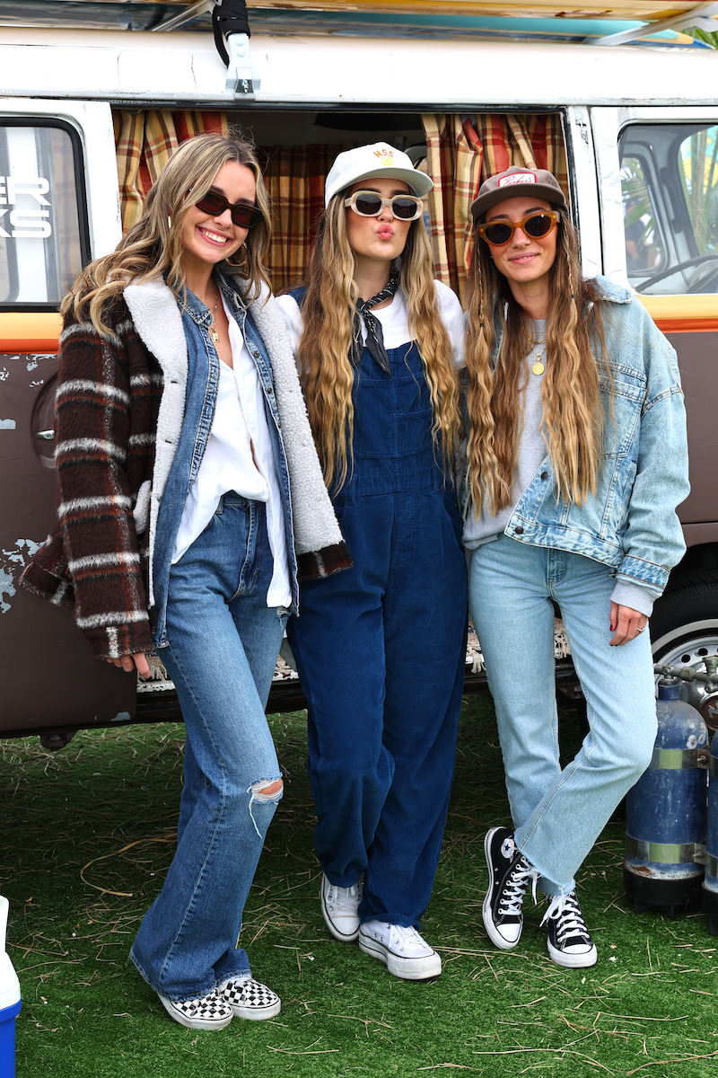 three women in front of a van