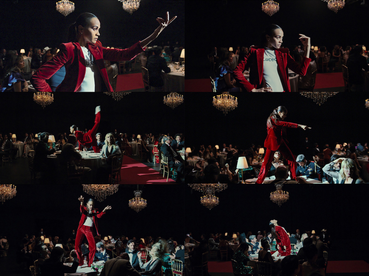 Rita (Zoe Saldaña) wears a red velvet suit in a fabulous dance sequence.