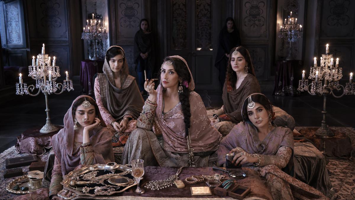 Aditi Rao Hydari as Bibbo, Manisha Koirala as Mallikajaan, Sanjeeda Sheikh as Waheeda, Richa Chadha as Lajjo sit around a table in ‘Heeramandi: The Diamond Bazaar.’