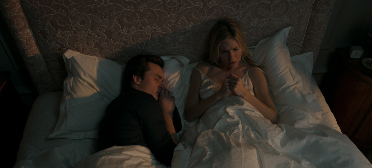 Sienna Miller and Rupert Friend sleep in bed in a scene from Anatomy of a Scandal