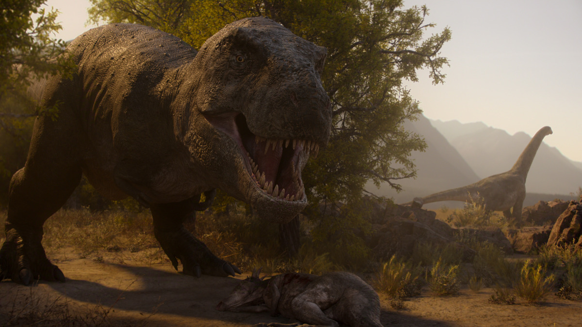 A large Tyrannosaurus rex stands in a prehistoric landscape near a carcass, roaring, with a long-necked sauropod dinosaur visible in the background and trees and mountains surrounding them in soft sunlight.