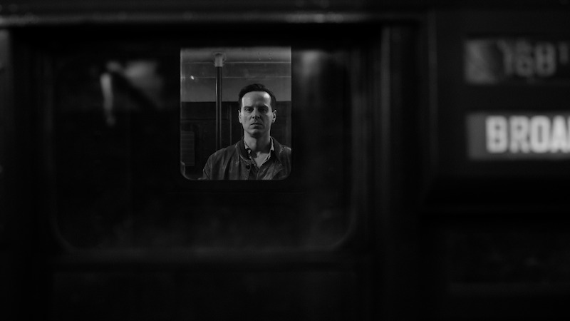 A view through a train window of Andrew Scott as Tom Ripley in 'Ripley'