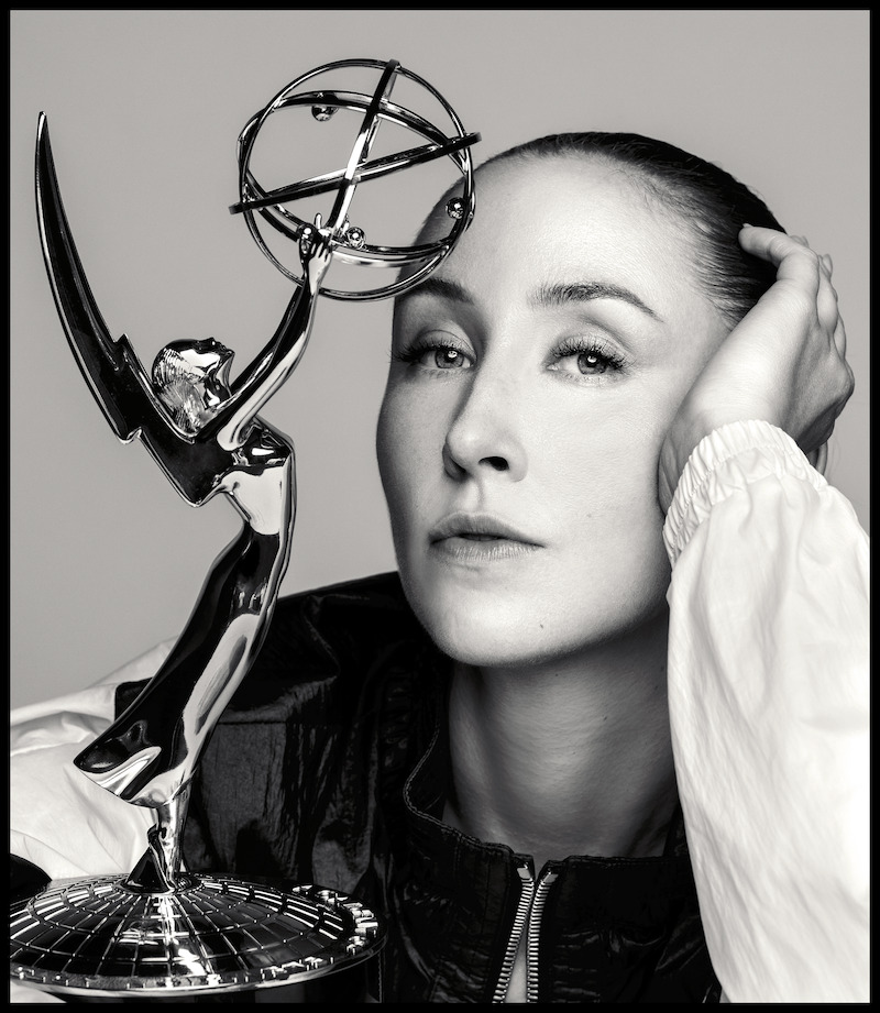 Erin Doherty poses with her Emmy close to her face.